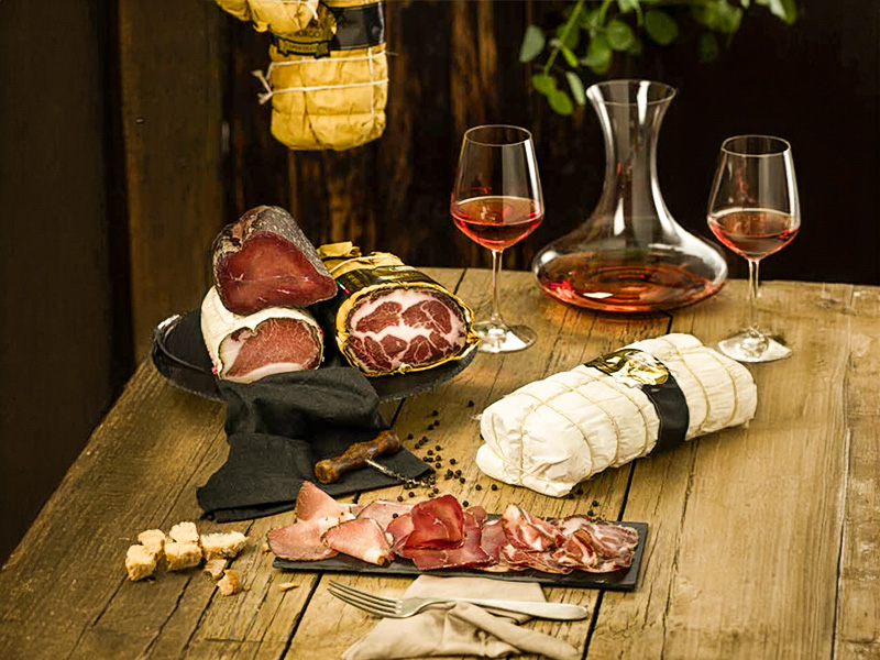 Coppa and Lombatella on a wooden table