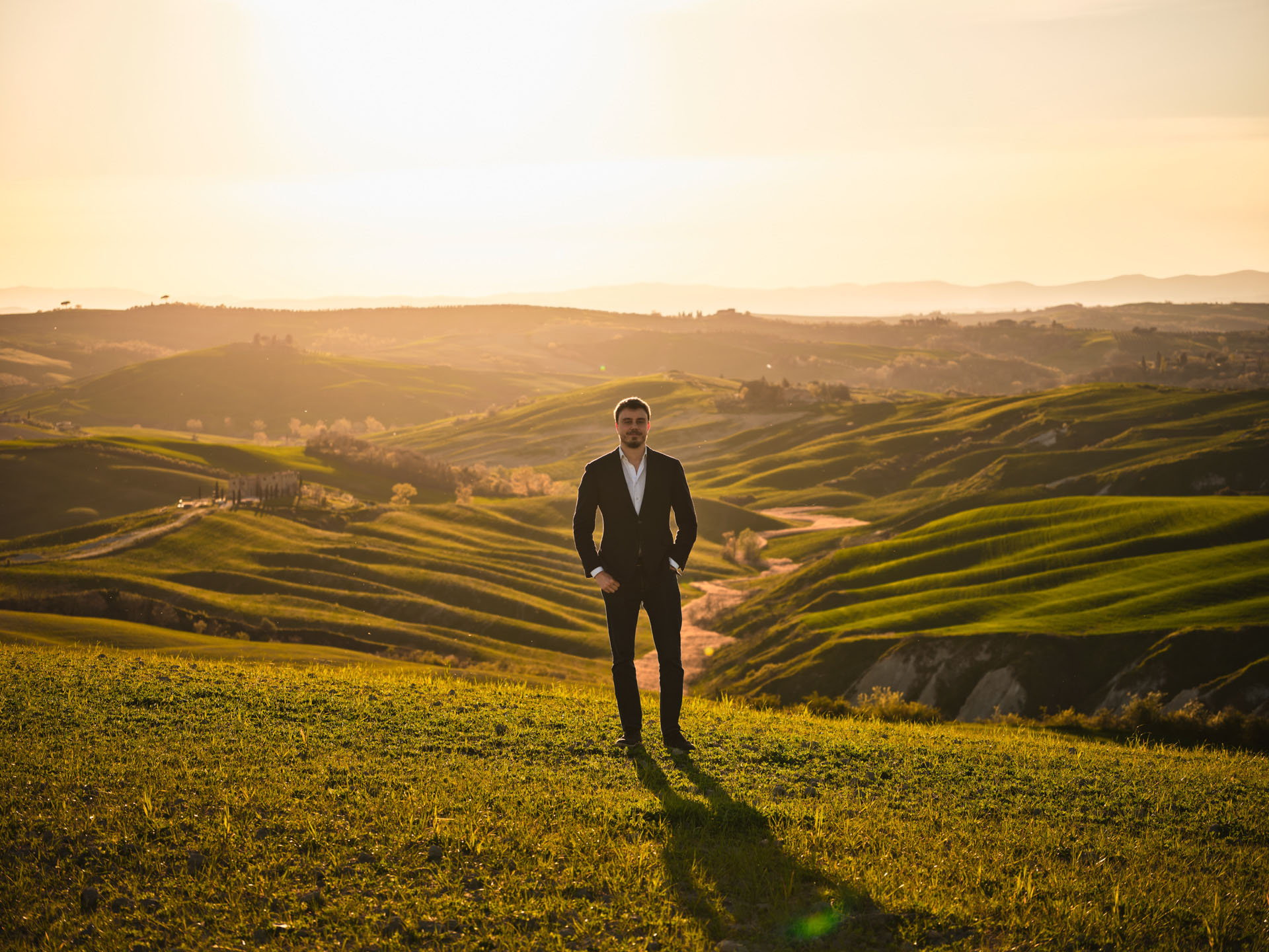 Picture of the founder standing in the Crete Senesi hills at sunset