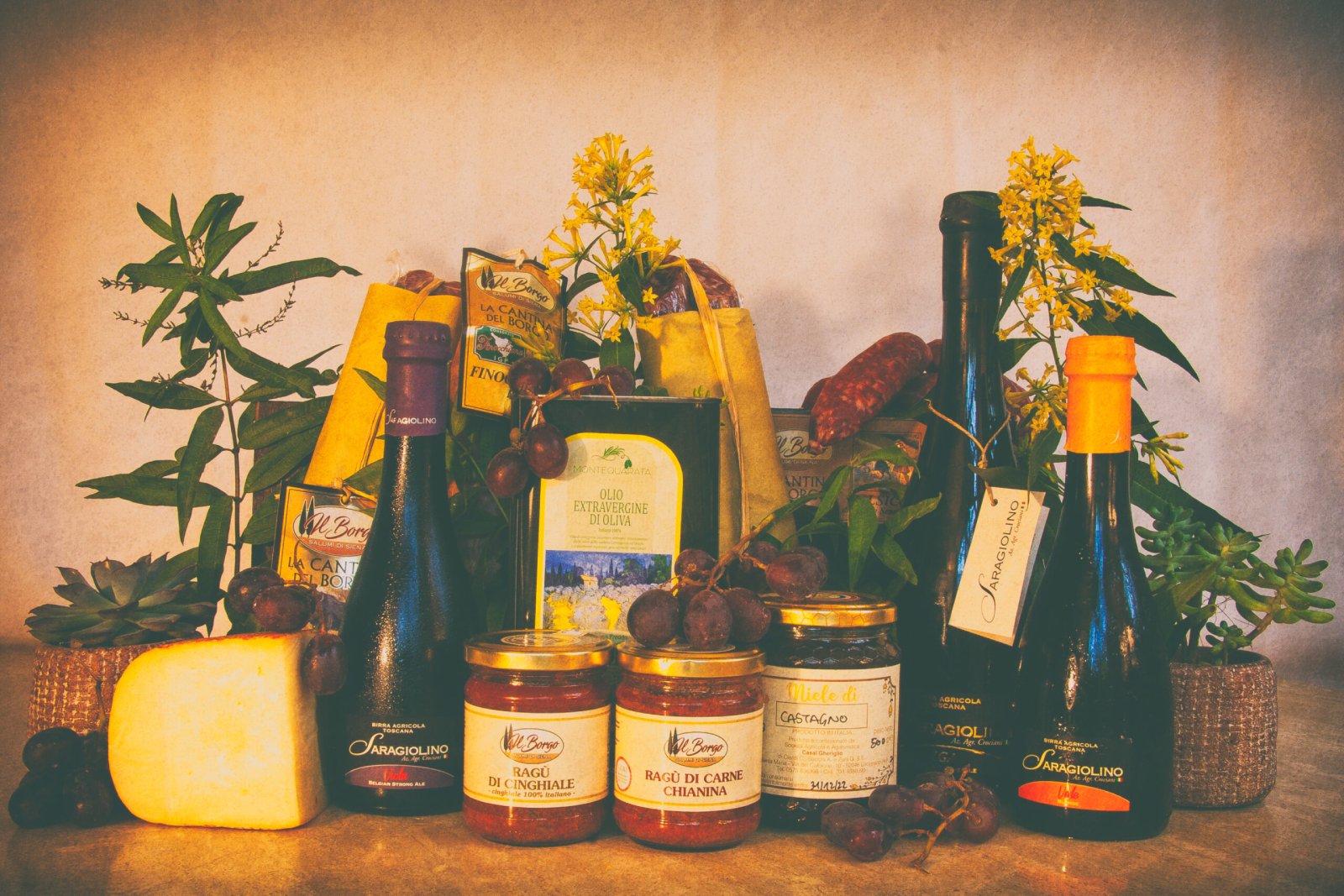 Assortment of Tuscan Delicacies with Extra Virgin Olive Oil, cheese, cold cuts and beers