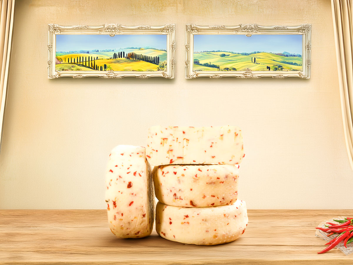 Pecorino di Pienza with Chilli Pepper – creamy sheep’s milk cheese from Tuscany infused with mild chilli pepper for a balanced, spicy flavour.